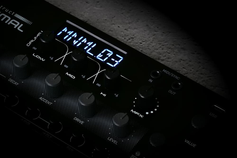 Close-up of a digital display and knobs on a music device.