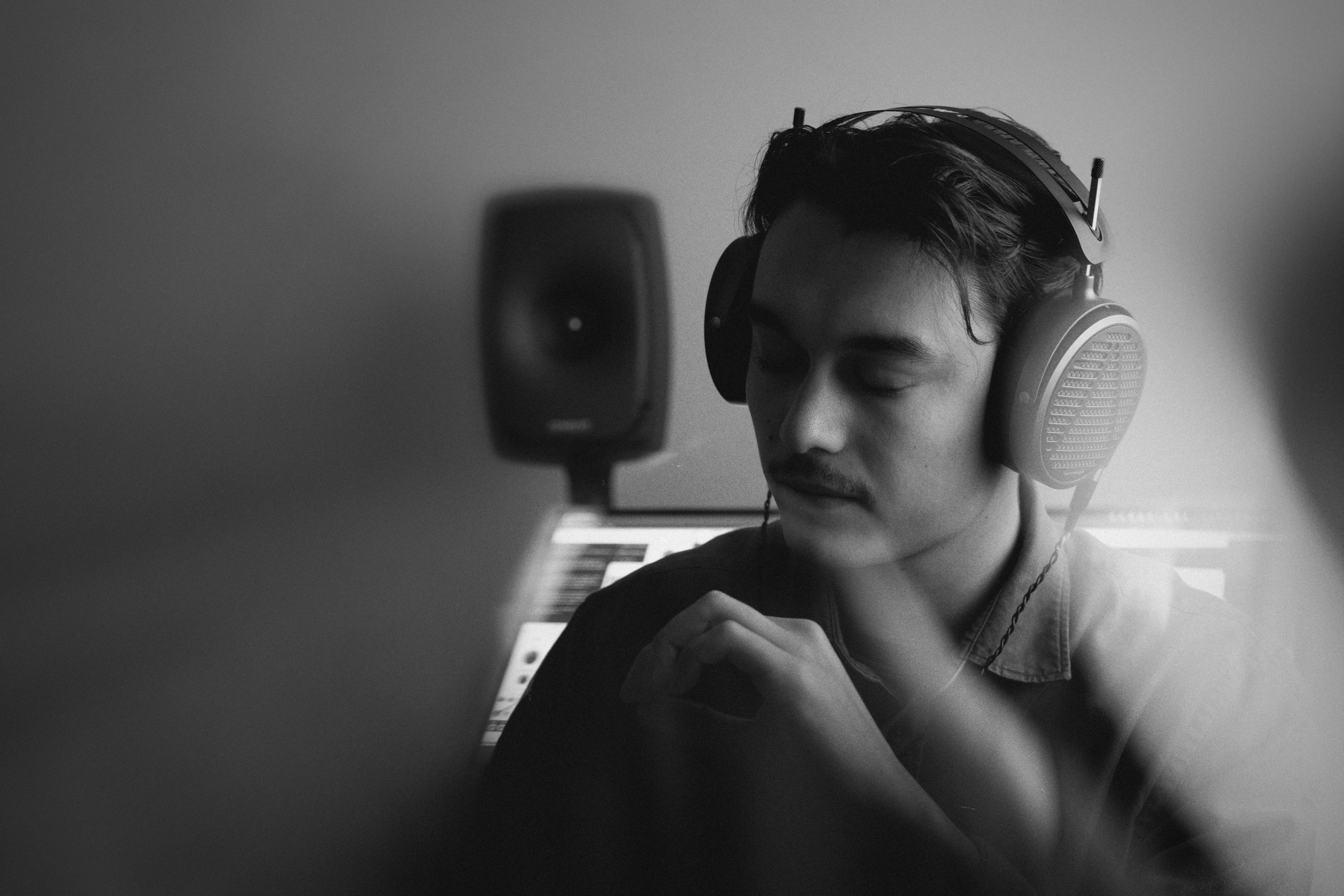 Liam Phan wearing Audeze MM-500 headphones in the studio