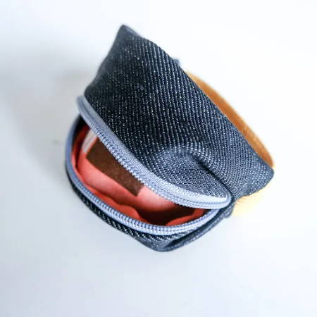 A finished home sewn wrist wallet with a zipper
