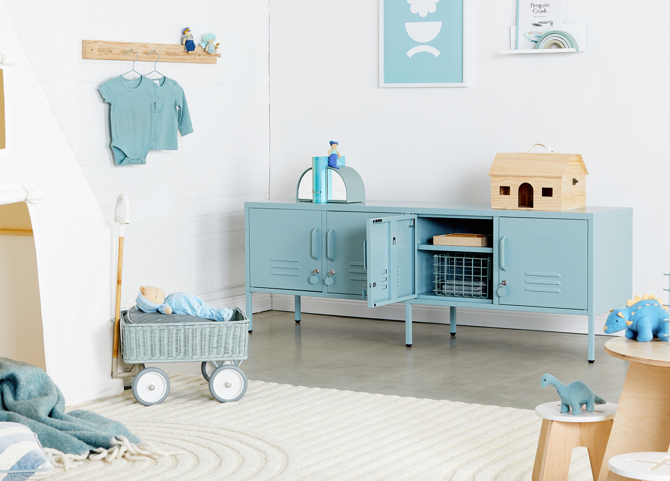Child's room with blue furniture, toys, and decorative elements.