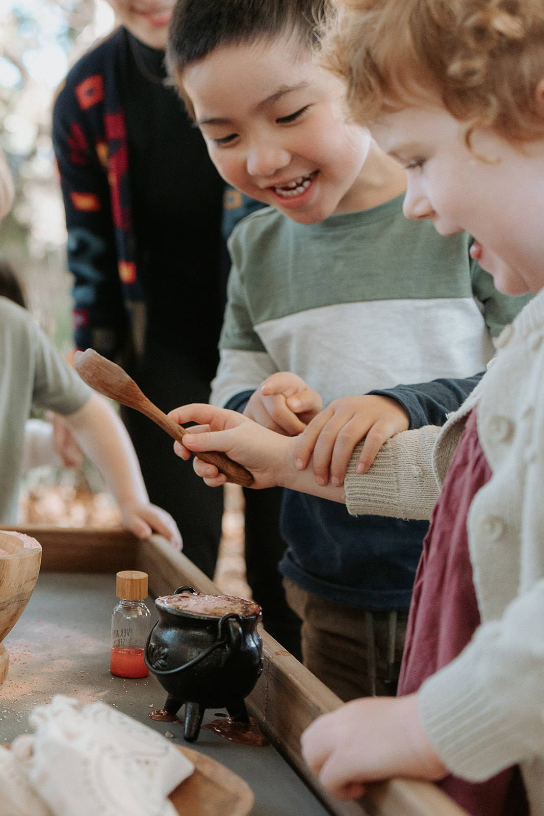 A Child delighting in Potion Play on a Castle & Cubby Sensory Play Table