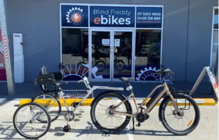 two electric bikes outside store
