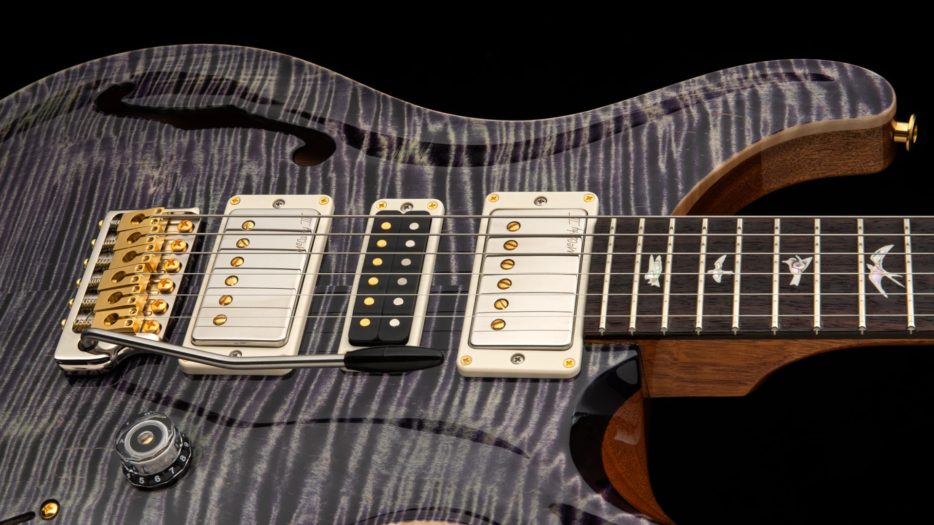 Close-up of a beautiful PRS Special-Semi-Hollow electric guitar with intricate wood grain and pickups.