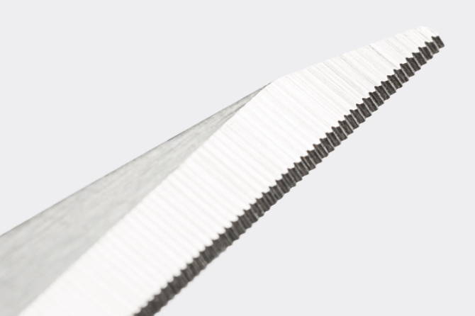 A close view of the small serration pattern on the Misen Kitchen Shears’ blade.