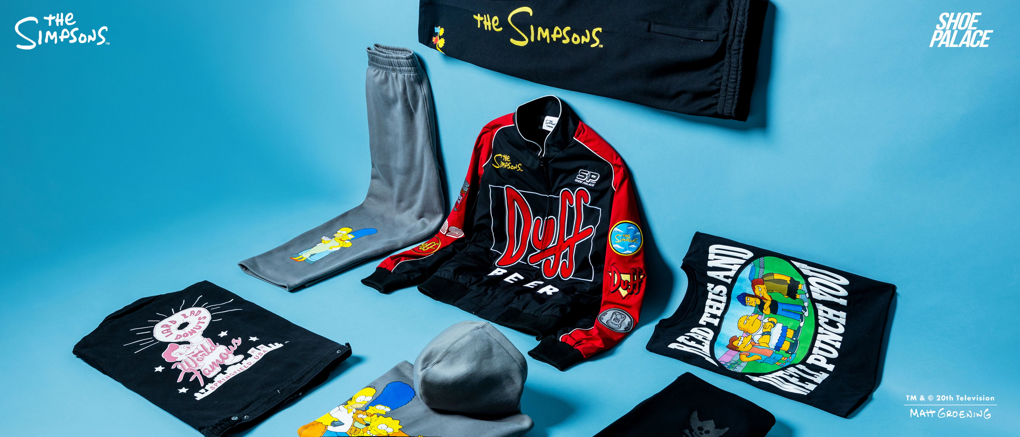 Assorted clothing items arranged on a blue background.