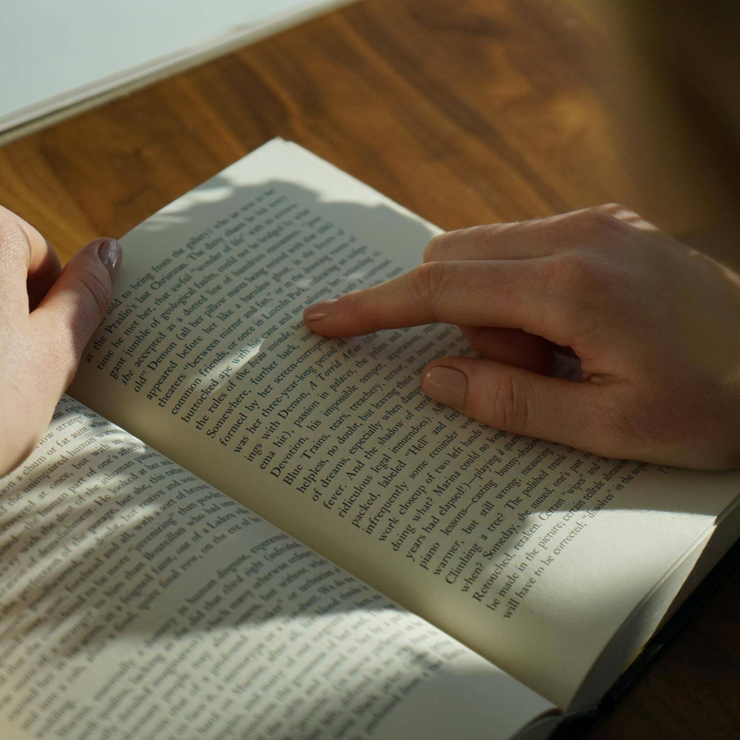 Person reading a book in their home.