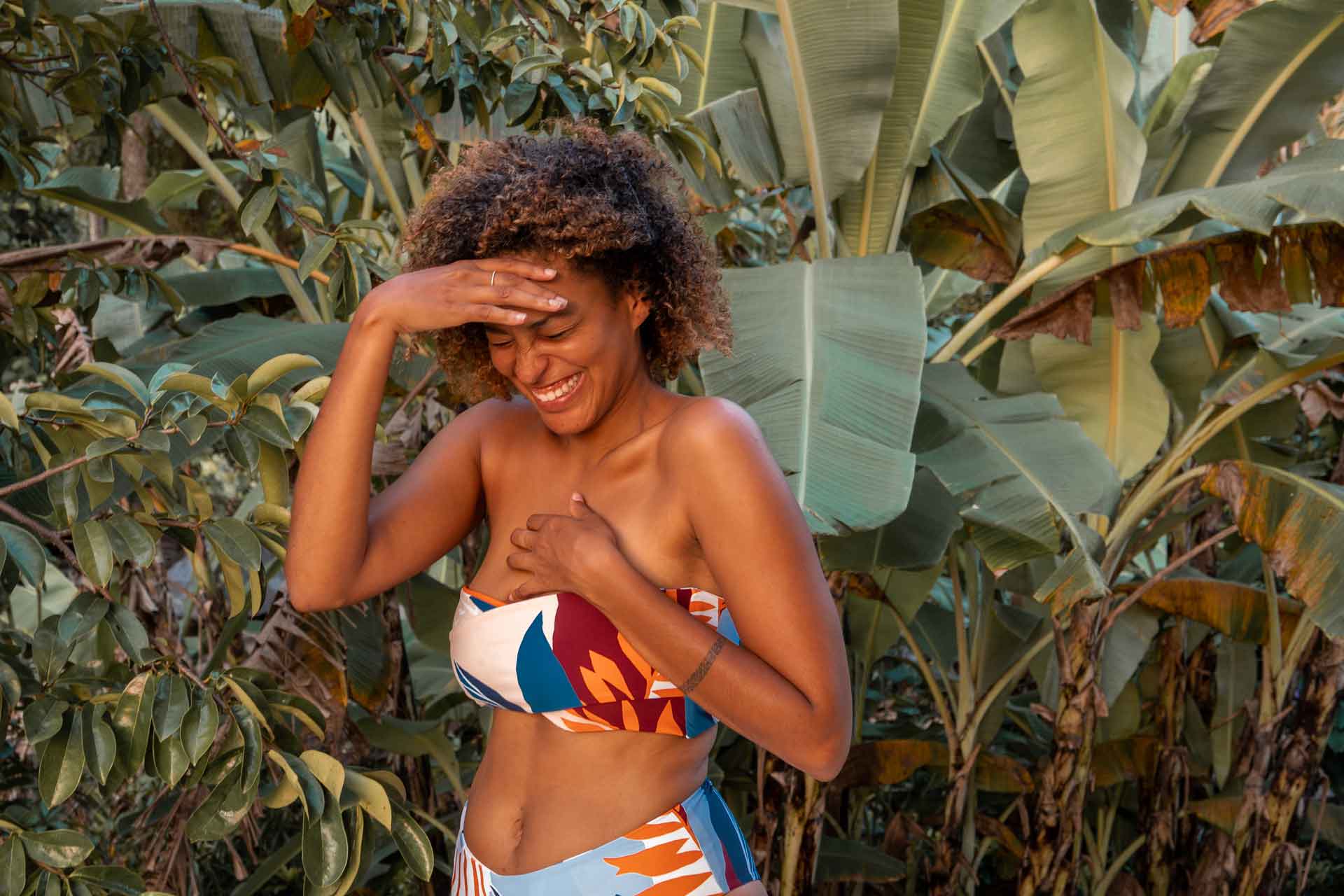 Woman wearing bikini with floral pattern smiling