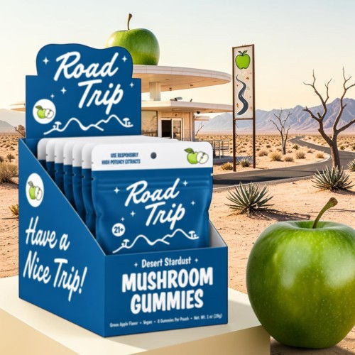 Display of mushroom gummies with a road trip theme and a green apple.