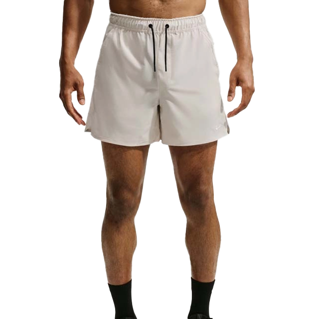 A person in white shorts and black socks standing.