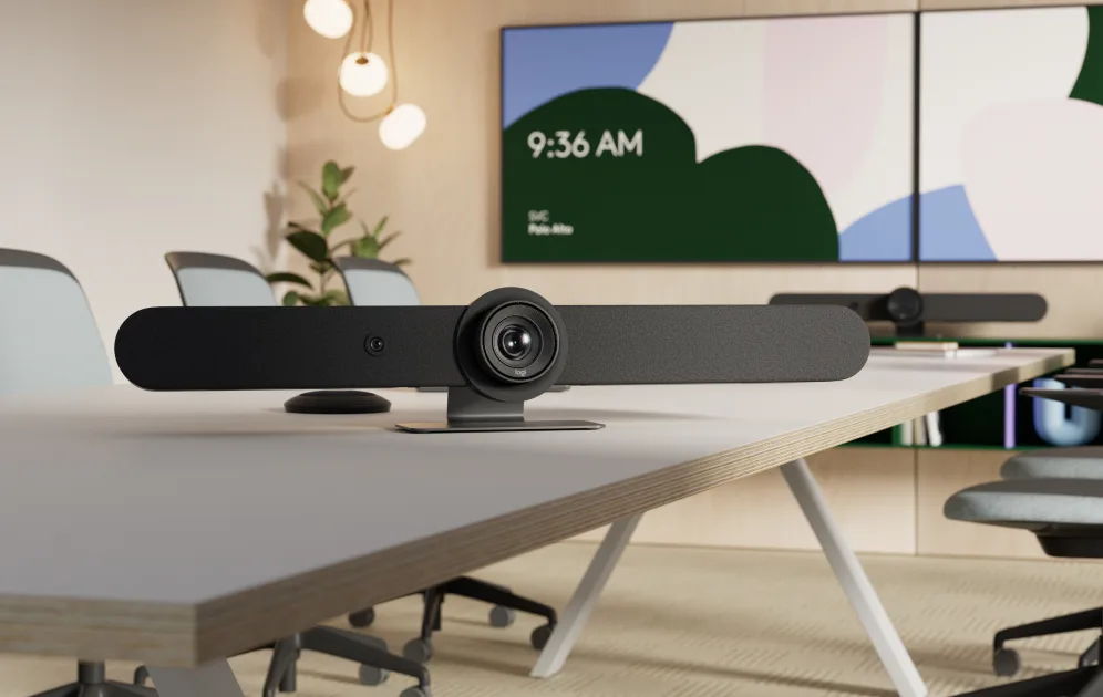 Conference room with a camera setup and digital clock on the wall.