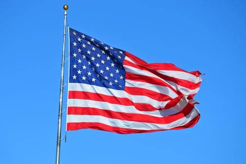 American Flag on Blue Sky Background