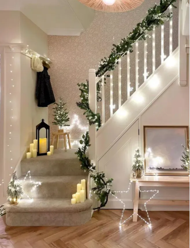 A star case with Osby stars, LED candles, mini Christmas trees and a lit up garland.
