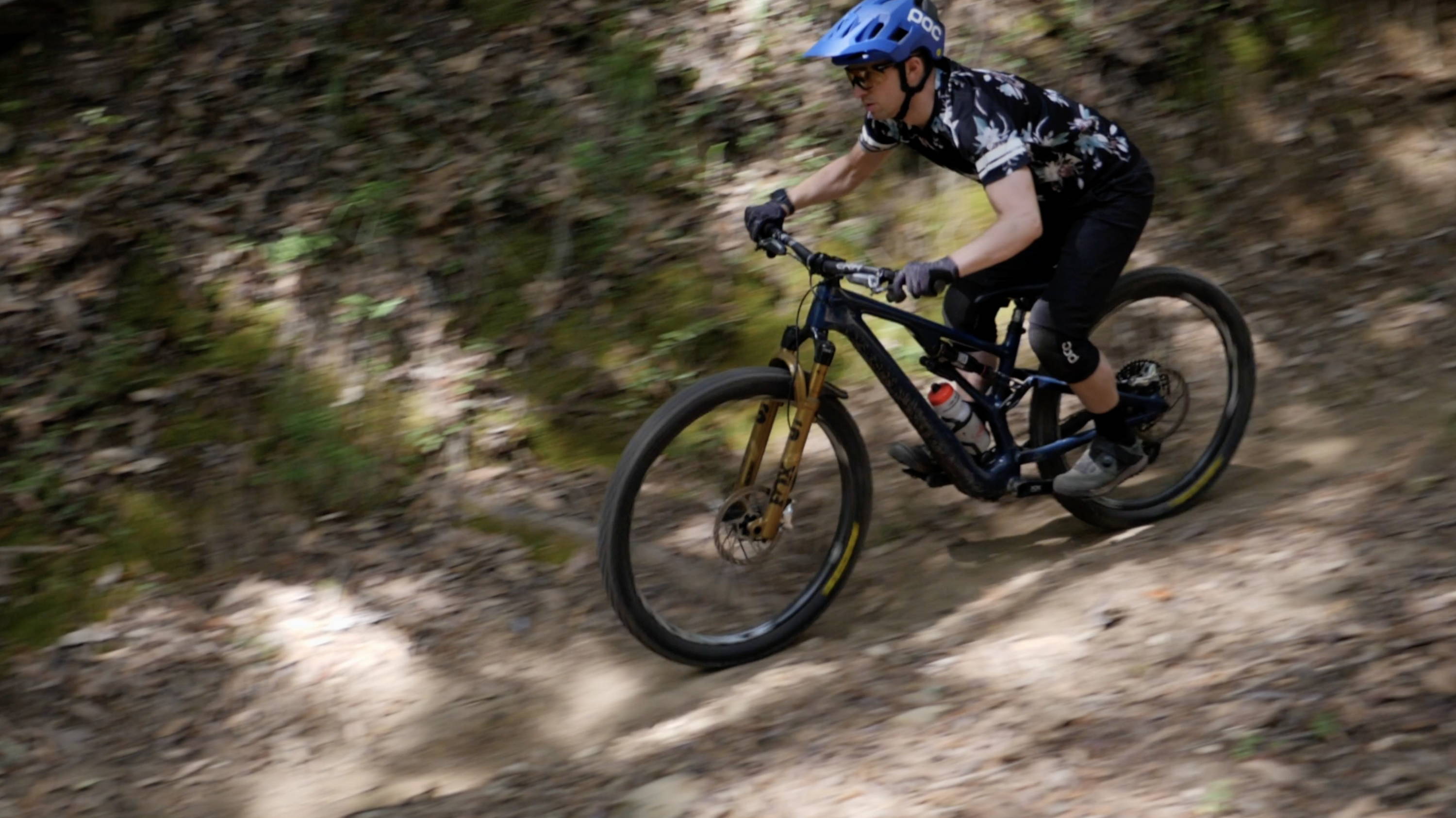 mountain biker riding specialized stumpjumper evo with fox factory 36 in podium gold with grip x damper riding in santa cruz california