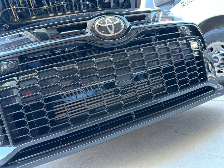 Front grille close-up with hidden horn placement behind honeycomb grille on Melissa's 2024 Toyota GR Corolla gallery photo 2