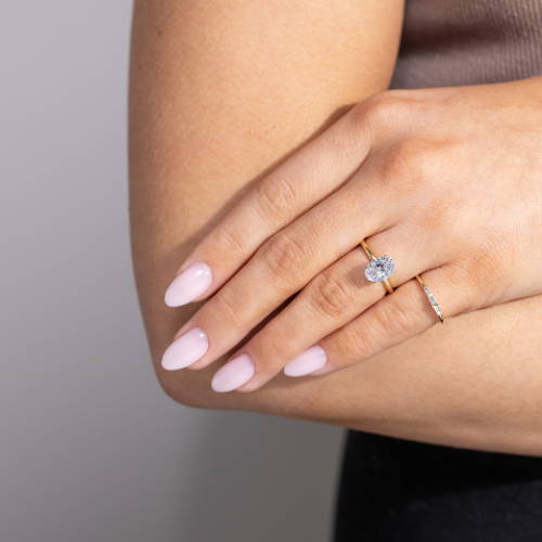 women wearing a solitaire engagement ring paired with a lab grown diamond accented pinky ring by MiaDonna
