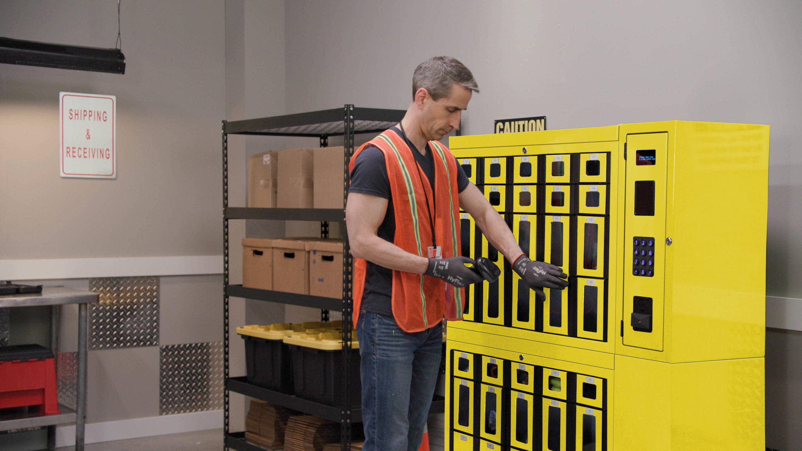 Man wearing safety vest and other PPE using Safety Source PPE Vending Lockers.