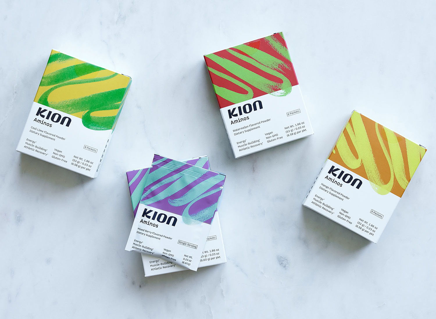 Four colorful product boxes arranged on a marble surface.