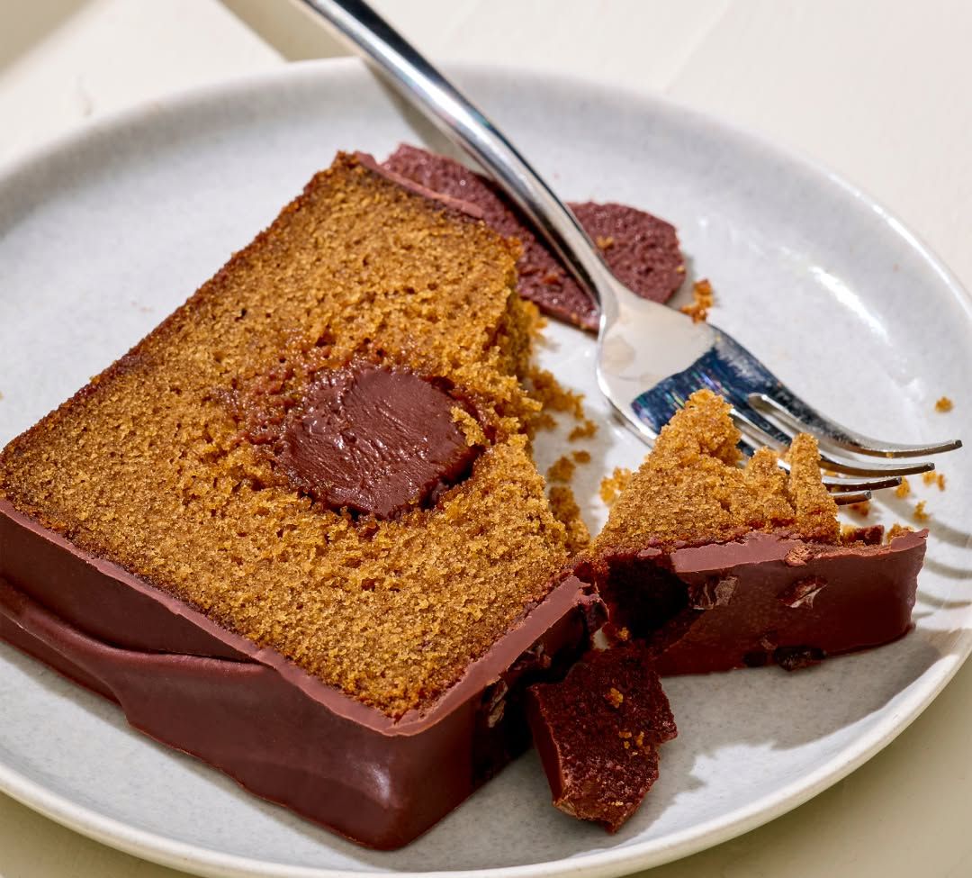 Slice of chocolate cake on a plate with a fork.