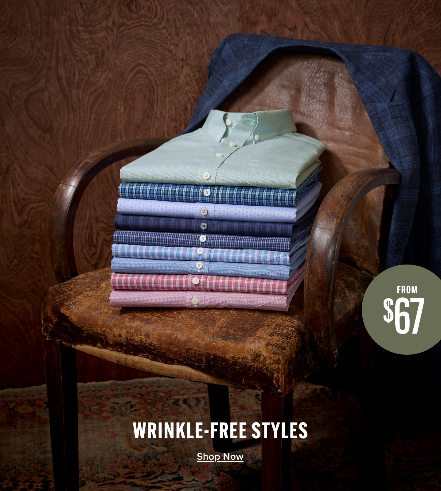 Stack of wrinkle-free shirts on a chair, priced from $67.