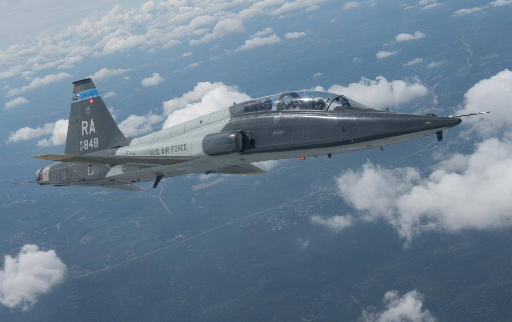 U.S. Air Force 1st Lt. Van Moreau, student pilot, front seat, and Maj. Herbie “Snooki” Veyran, instructor pilot, back seat, both assigned to the 435th Flying Training Squadron, fly a 12th Flying Training Wing Northrop T-38 Talon and conduct a battle damage check at Joint Base San Antonio-Randolph, Texas, August 25, 2022. A battle damage check is the process pilots use to check each other's airframes for any types of damage they may have sustained while flying. (U.S. Air Force photo by Senior Airman Tyler McQuiston)