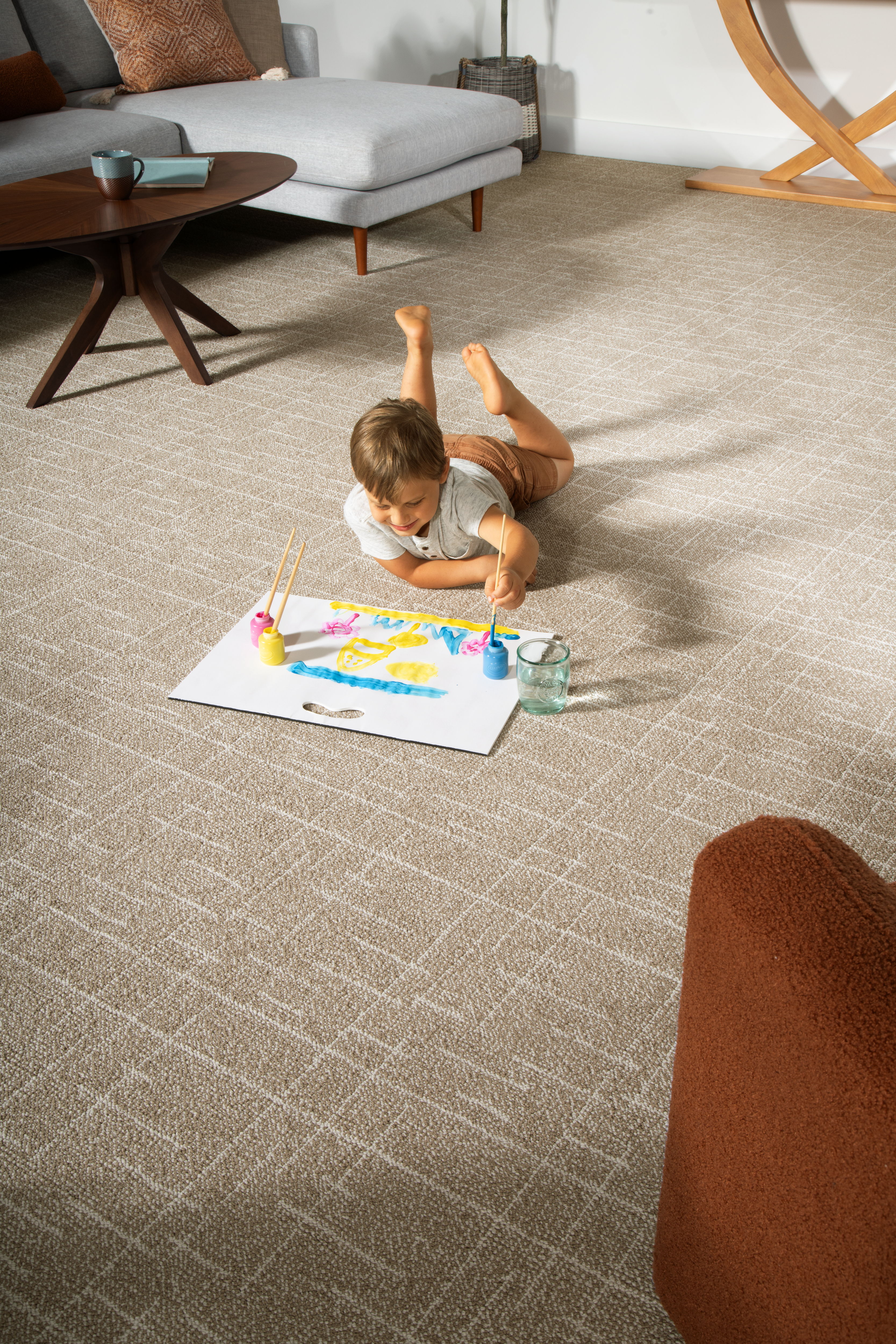 child doing artwork laying on SmartStrand carpet