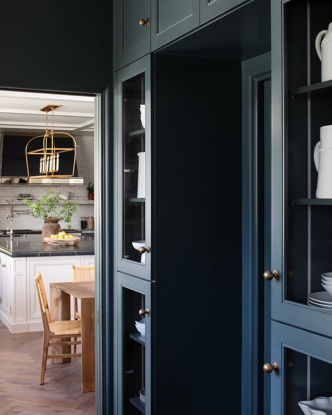 Navy and white kitchen with brass hardware and accessories