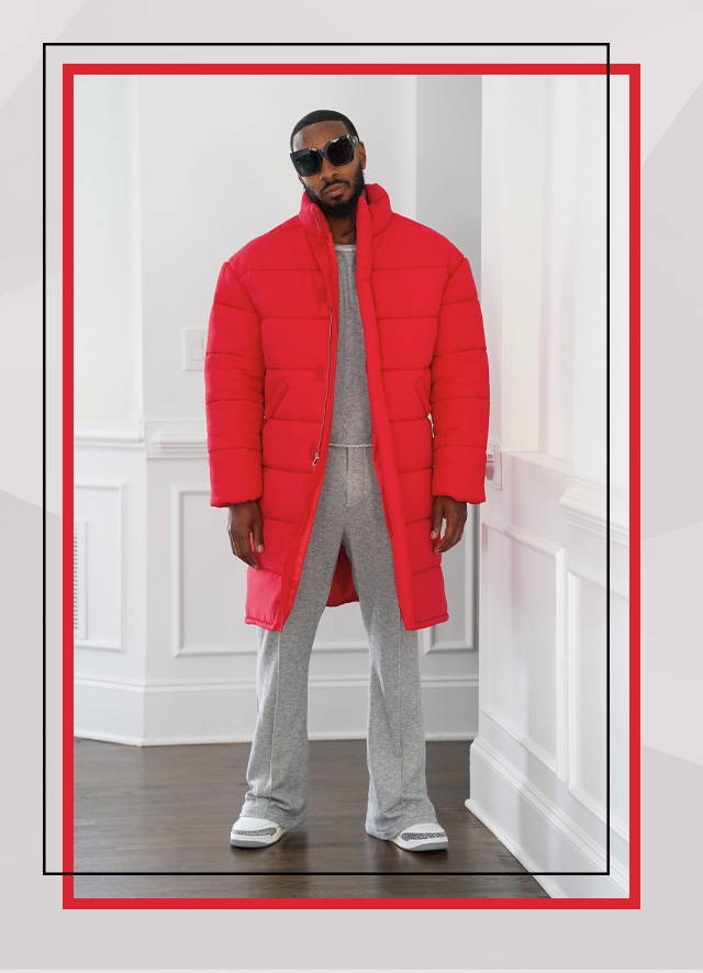 Male model wearing a red puffy jacket and sweatpants