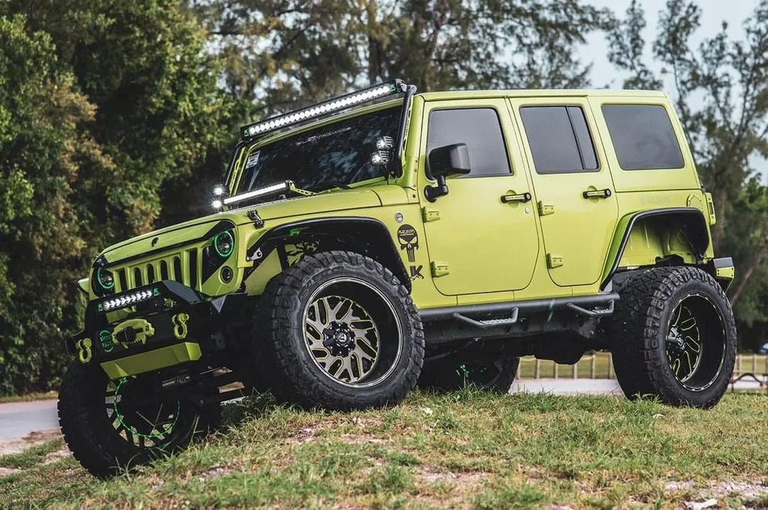 Front-three-quarter Omar's 2016 Jeep Wrangler exterior seven-slot grille round headlights bumper Shocker XL train horn featured customer install photo 1