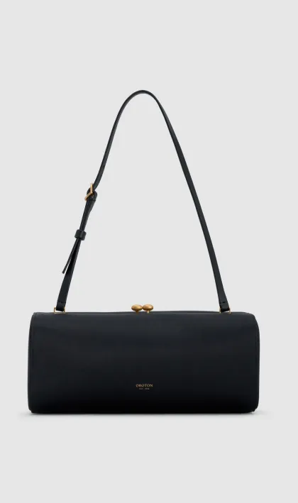 Black cylindrical handbag with a shoulder strap and gold clasp.
