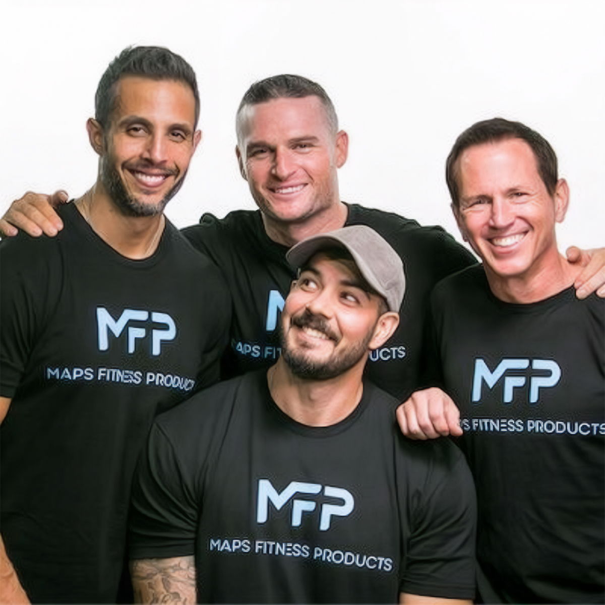 Four men in matching t-shirts posing together, smiling at the camera.