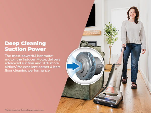 Woman vacuuming with a powerful vacuum cleaner in a cozy living room setting.