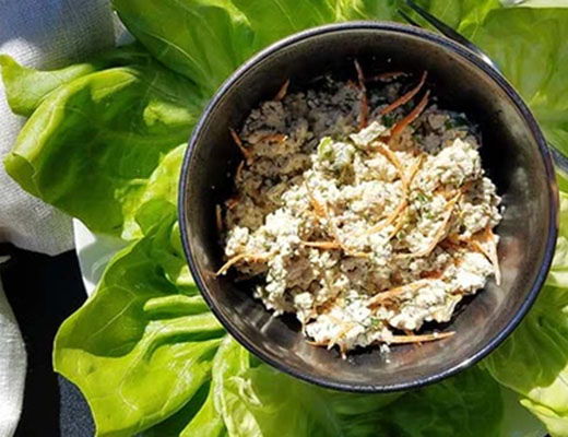 Bowl of crab salad served on fresh lettuce leaves.