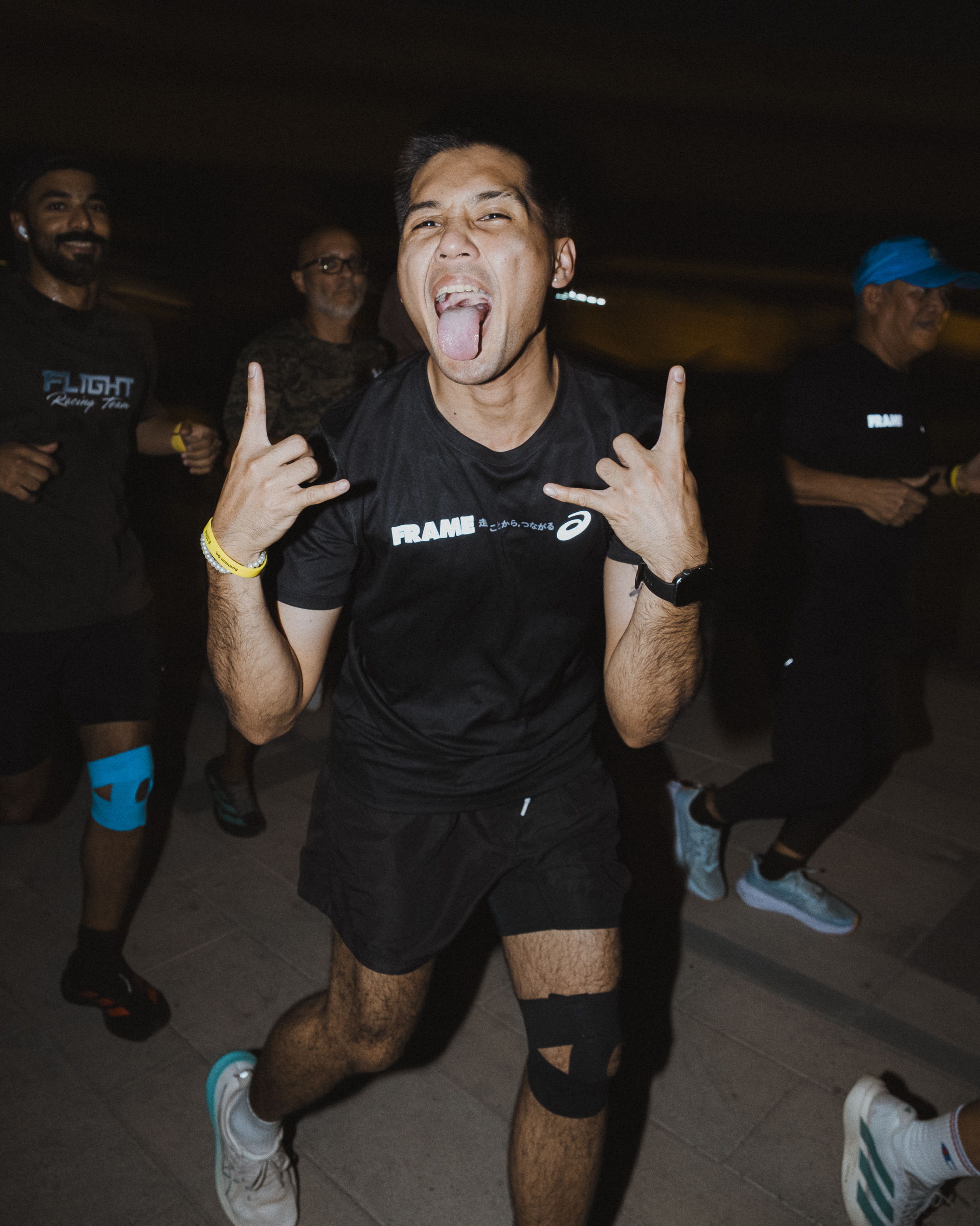 Runners enjoying a community run along the Dubai Canal during Global Running Day with ASICS and FRAME RUN CLUB in Dubai Design District.