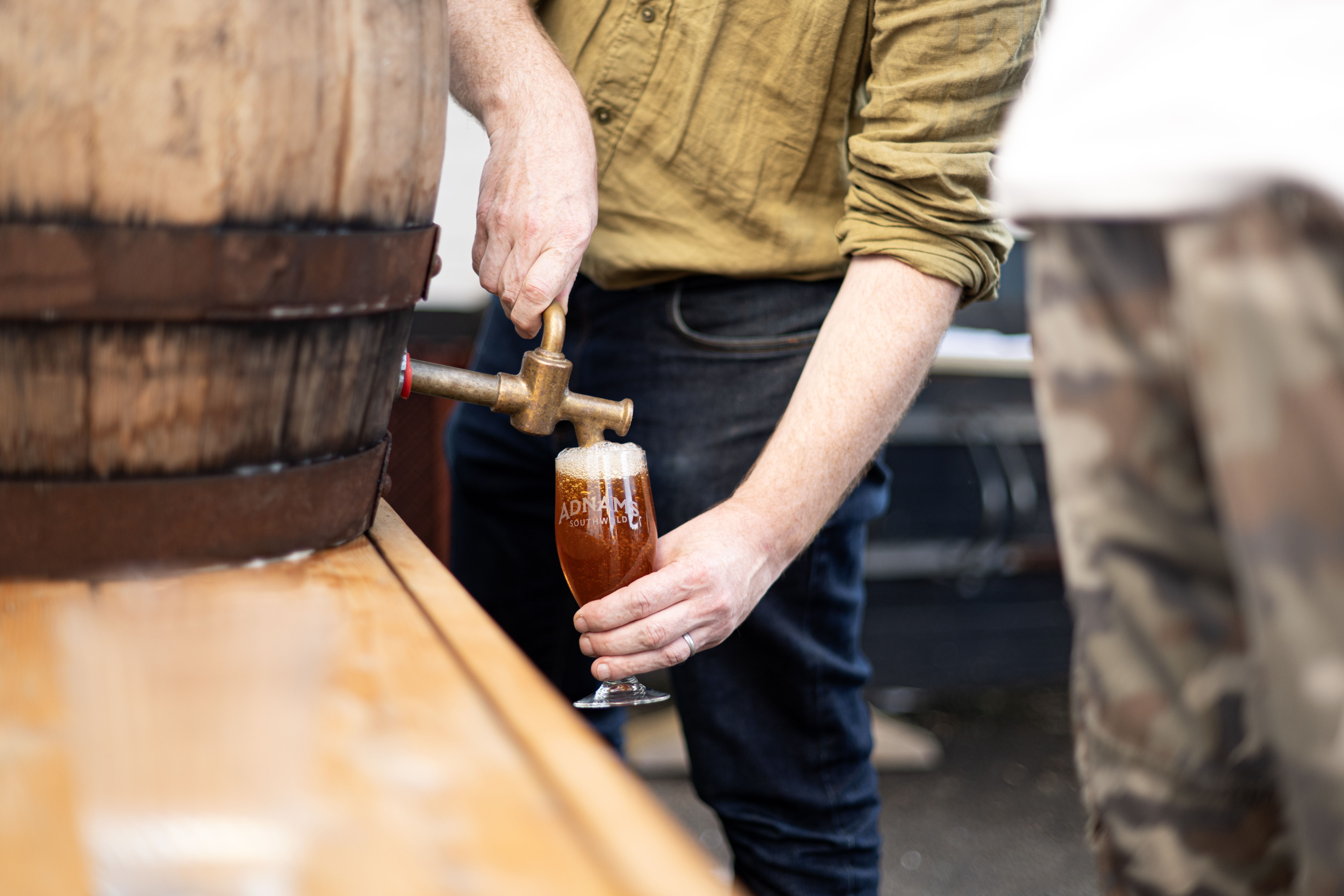 Fergus pouring Extra from a barrel into a glass.