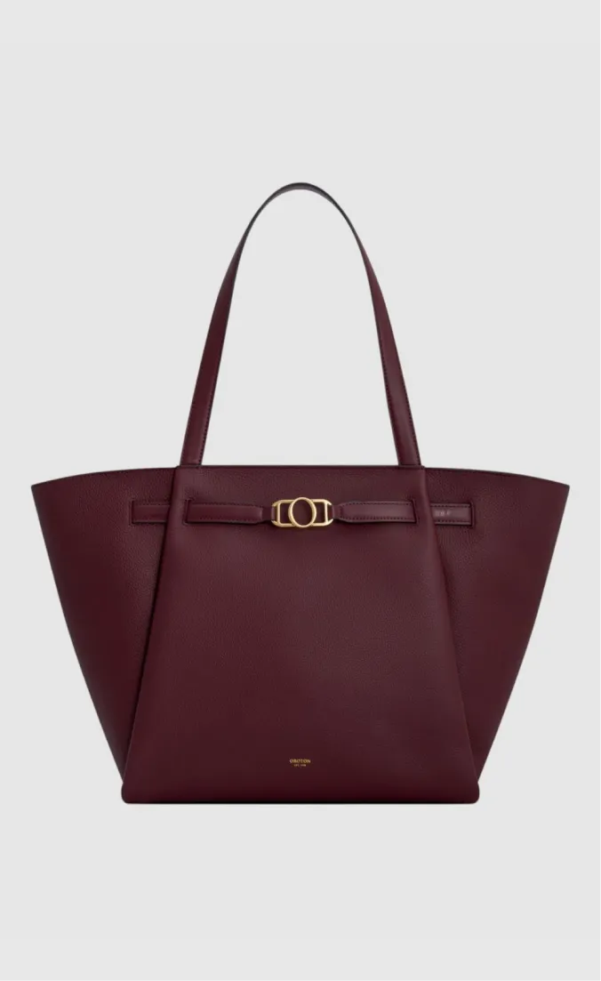 Maroon tote bag with gold buckle detail and two handles.