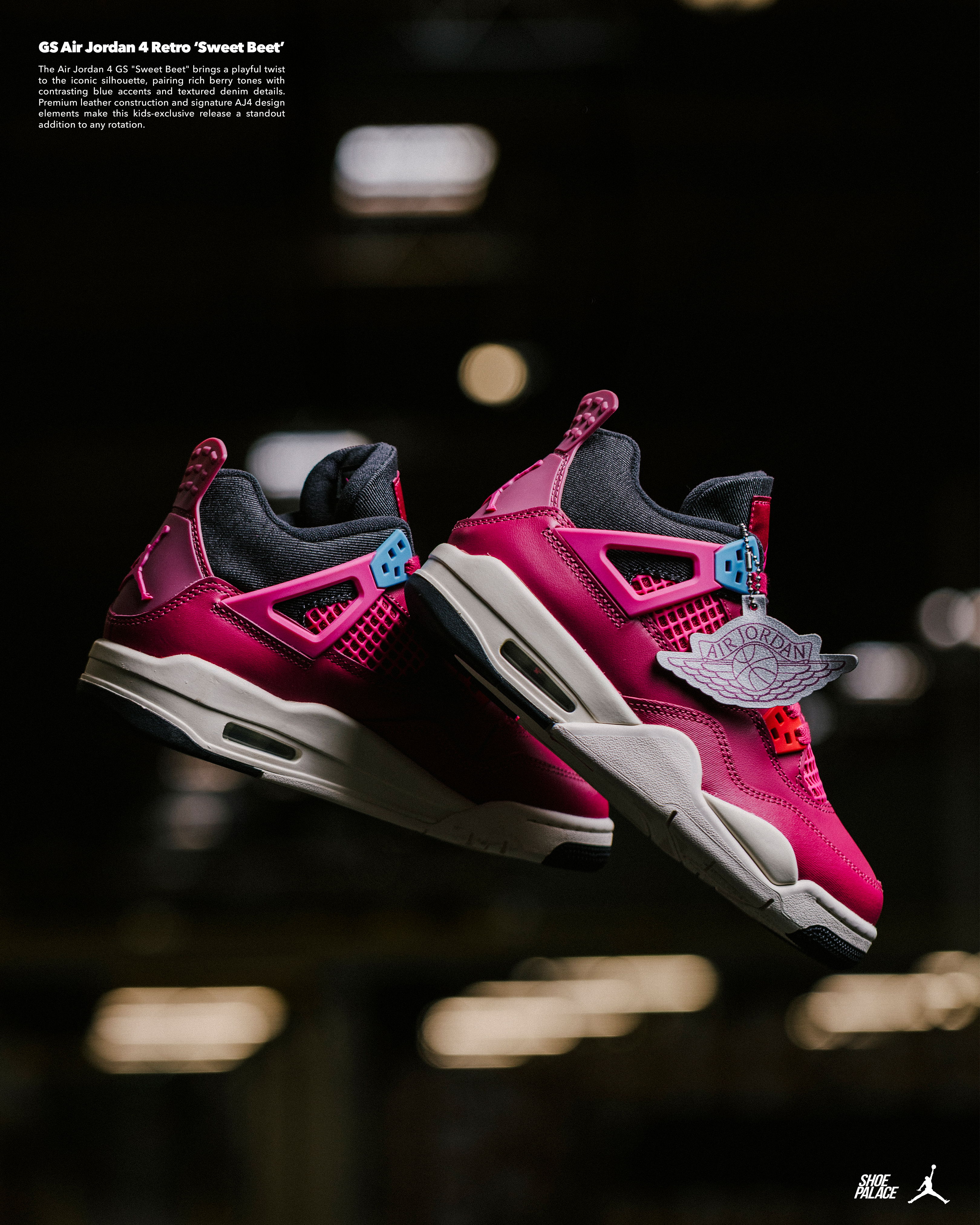 Pink and grey Air Jordan sneakers displayed against a blurred industrial background.