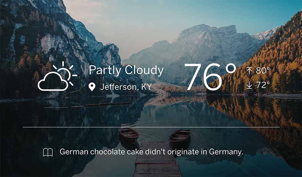 wall oven LCD display featuring a mountainous landscape view behind the weather forecast and a fun fact: German chocolate cake didn't originate in Germany.