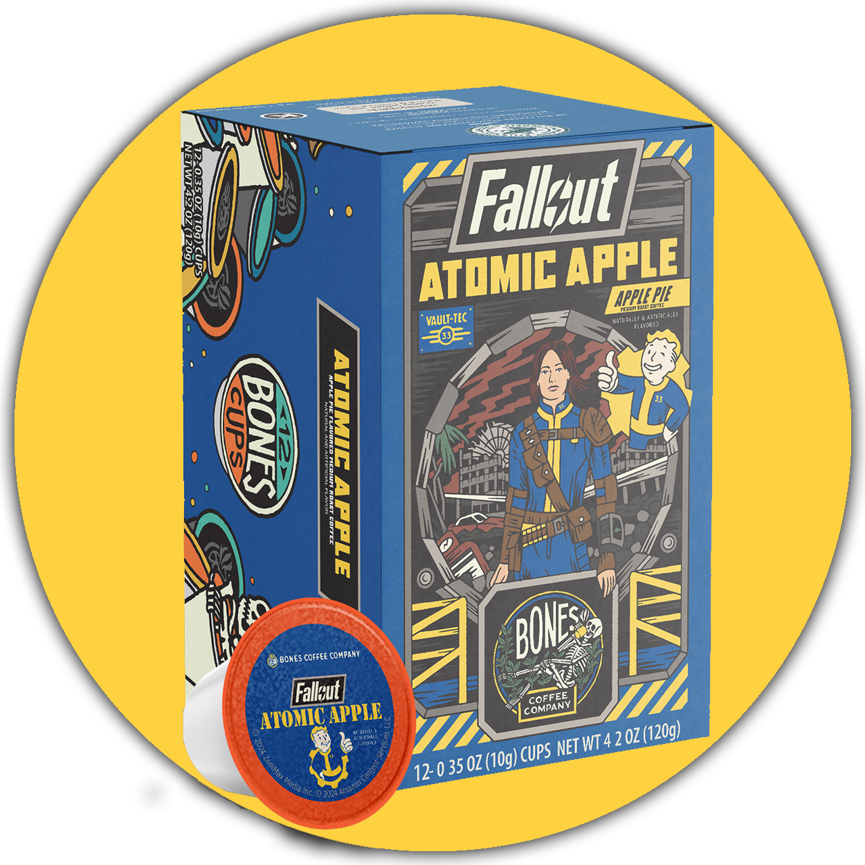 A box of Bones Cups flavored coffee inspired by Fallout named Atomic Apple. Its flavor is apple pie. On the art is Lucy from the Fallout show, and behind the box is a yellow circle.