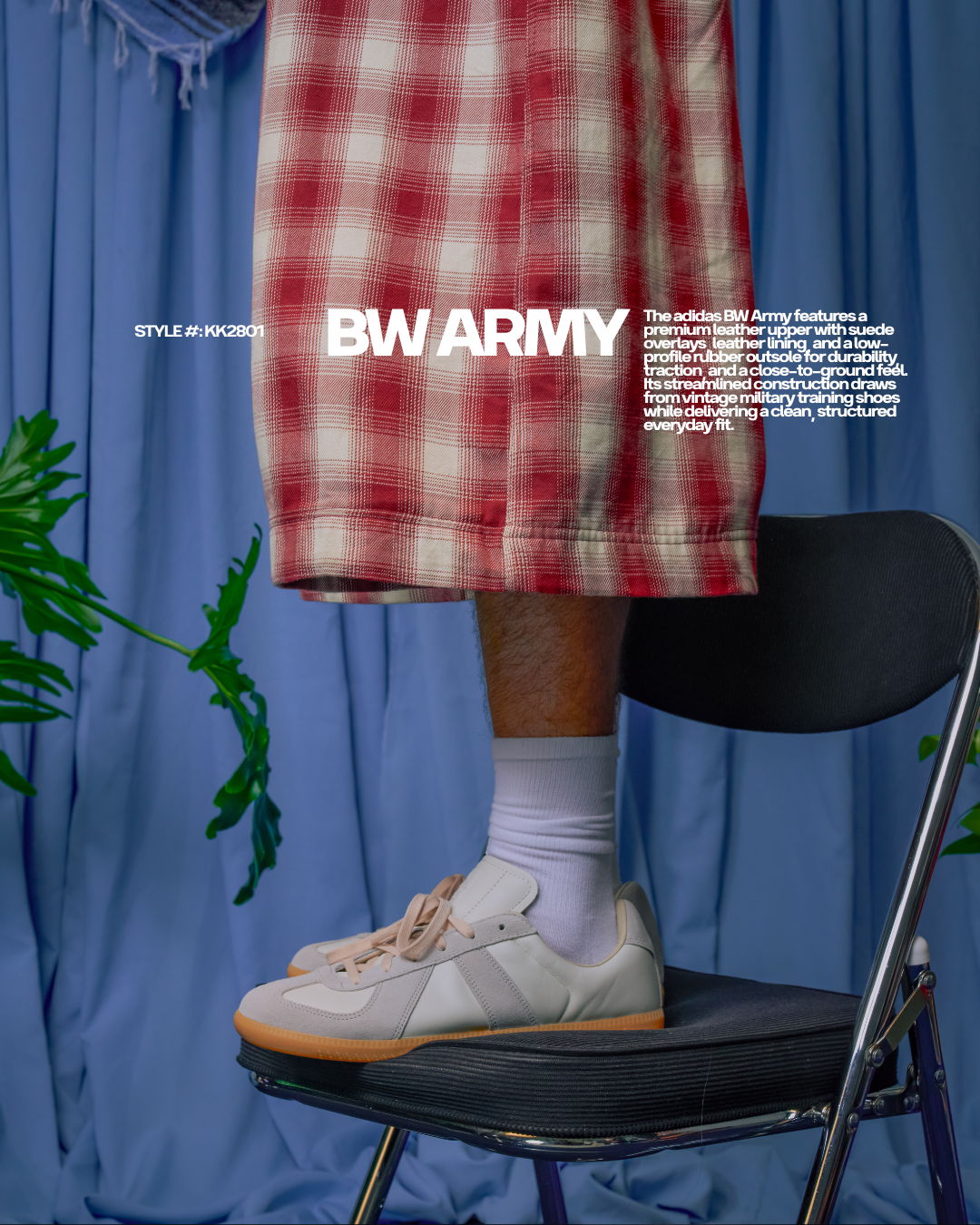 Person standing on a chair, wearing a plaid skirt and sneakers.