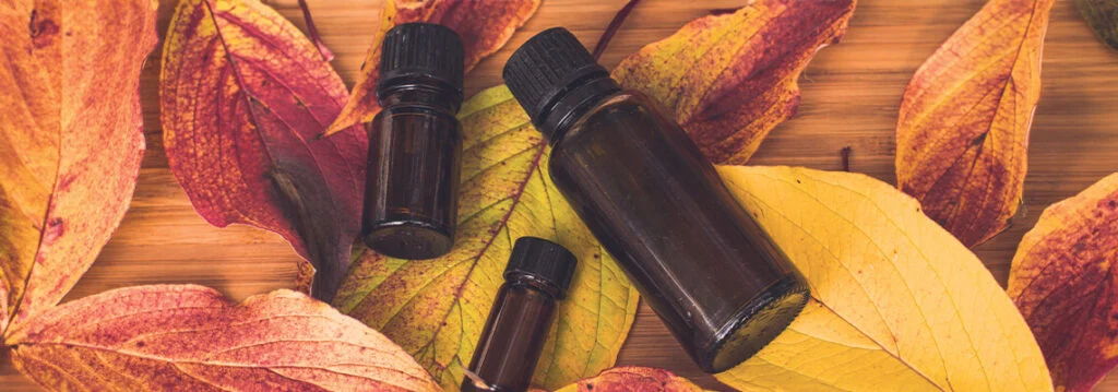 Bottles on autumn leaves, creating a warm and natural atmosphere.