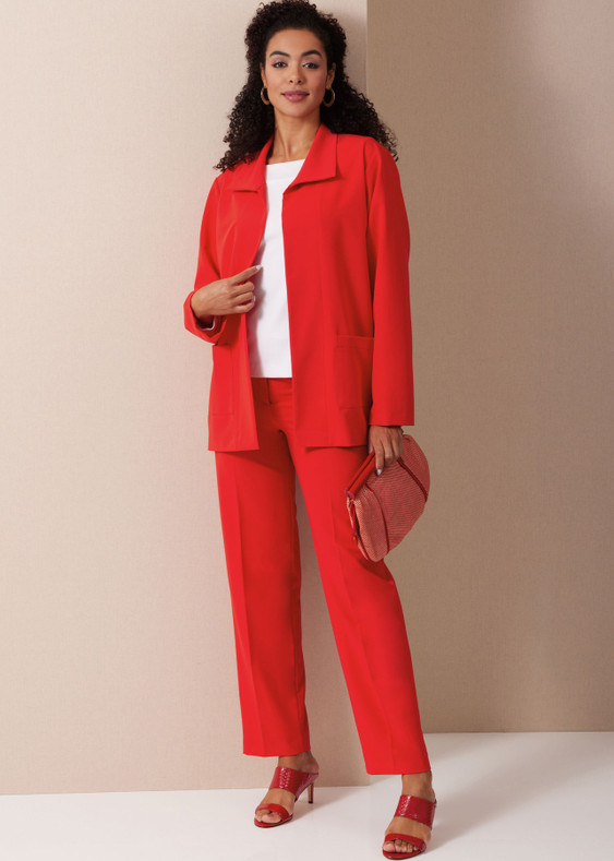 Woman in a red suit holding a clutch bag, standing against a neutral backdrop.