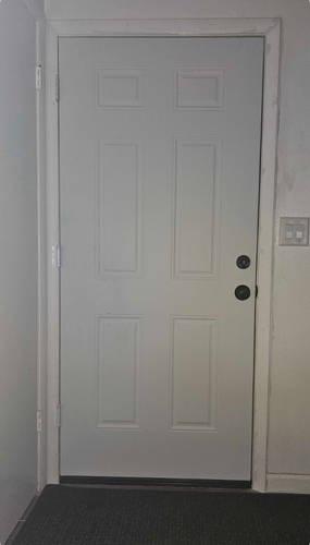 poorly sealed front door with trim covering