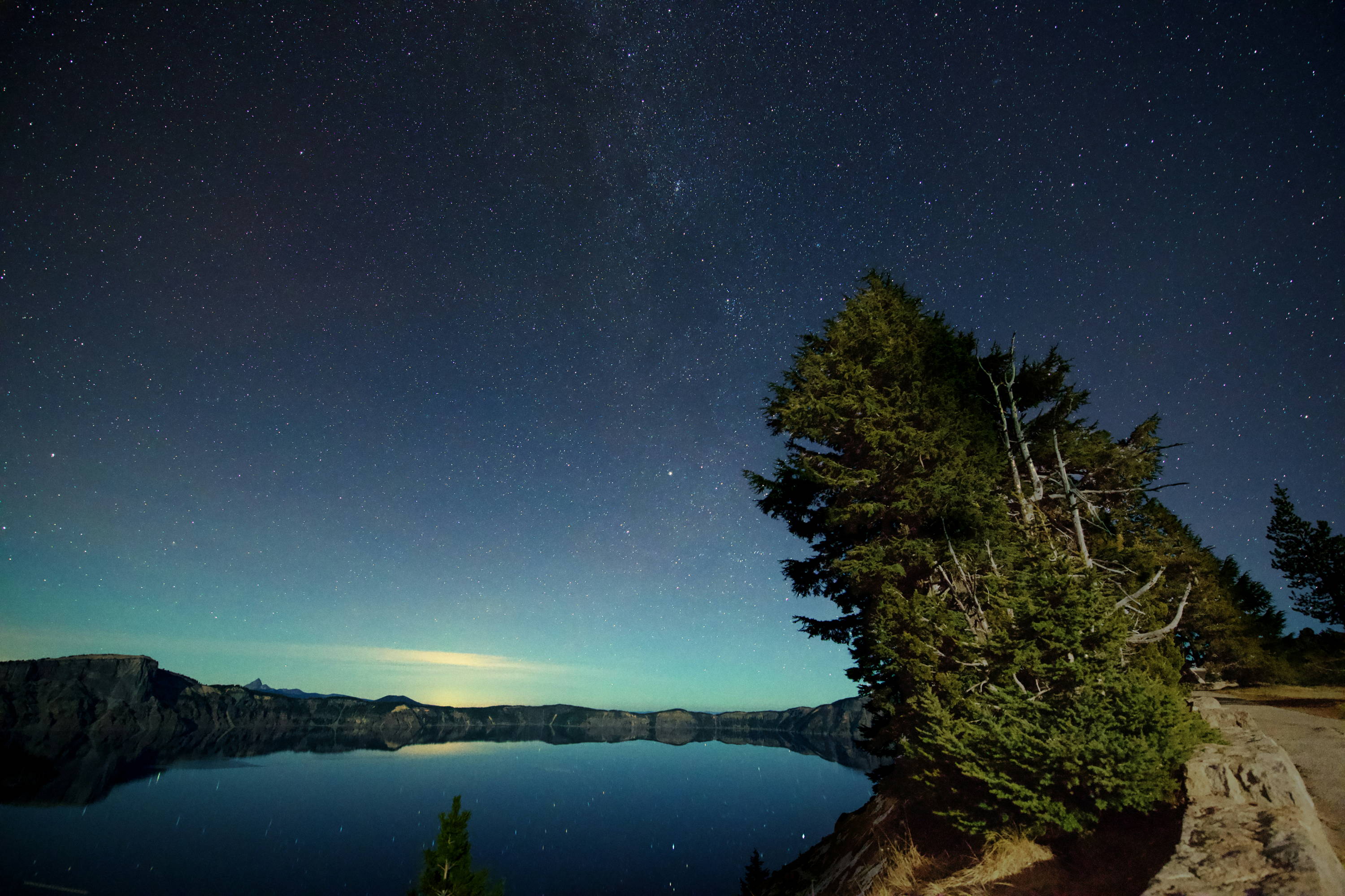 Crater Lake National Park night sky and stars over the lake.