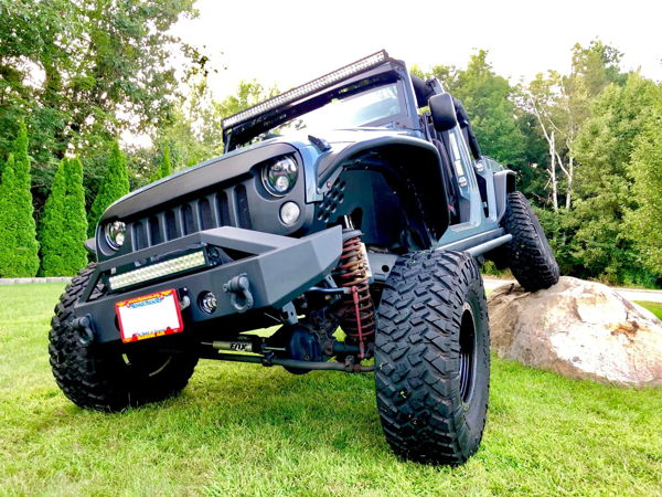 Front quarter dark blue Jeep Wrangler Rubicon on boulder FOX shocks angry grille LED light bar Donn's 2014 Rubicon Conductor's Special 244 Nightmare Edition gallery photo 2