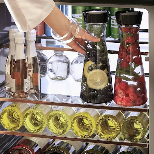 Woman taking a decanter of water out of Café beverage center
