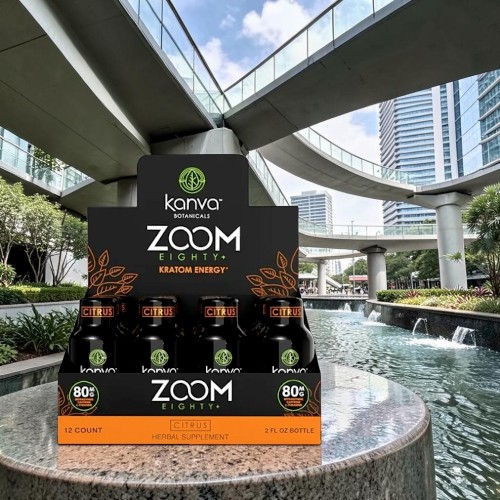 Display of Kanva Zoom energy drinks near a modern urban setting.