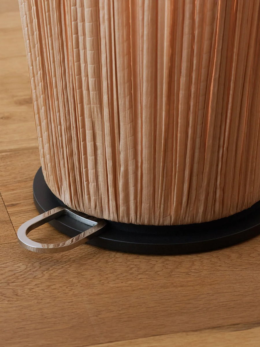 A close-up of a textured cylindrical object on a wooden surface.
