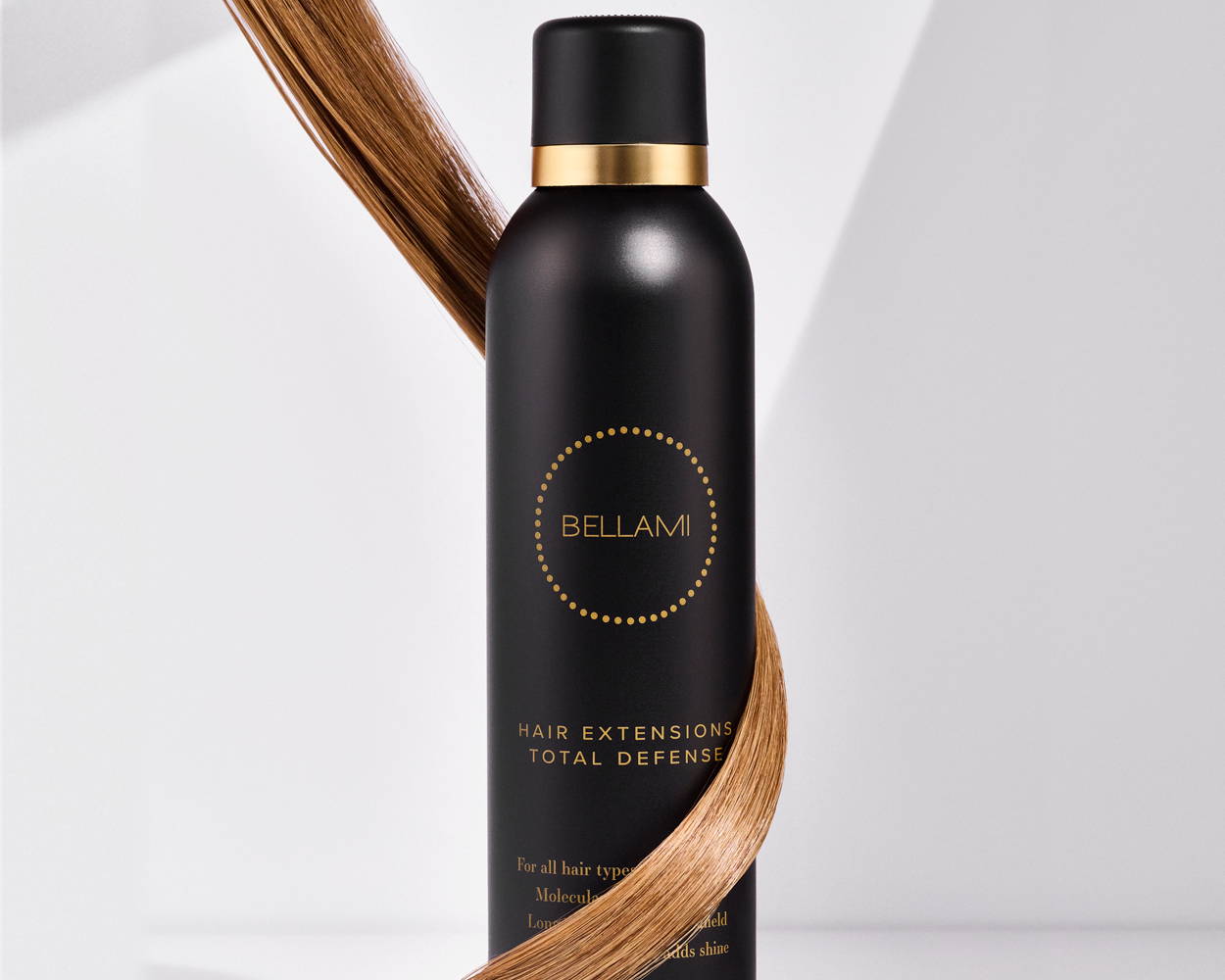 Bellami Hair Extensions Total Defense spray bottle with a strand of light brown hair wrapped around it.