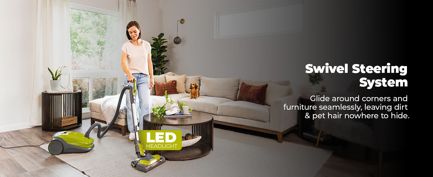 Woman vacuuming in a modern living room with LED display.