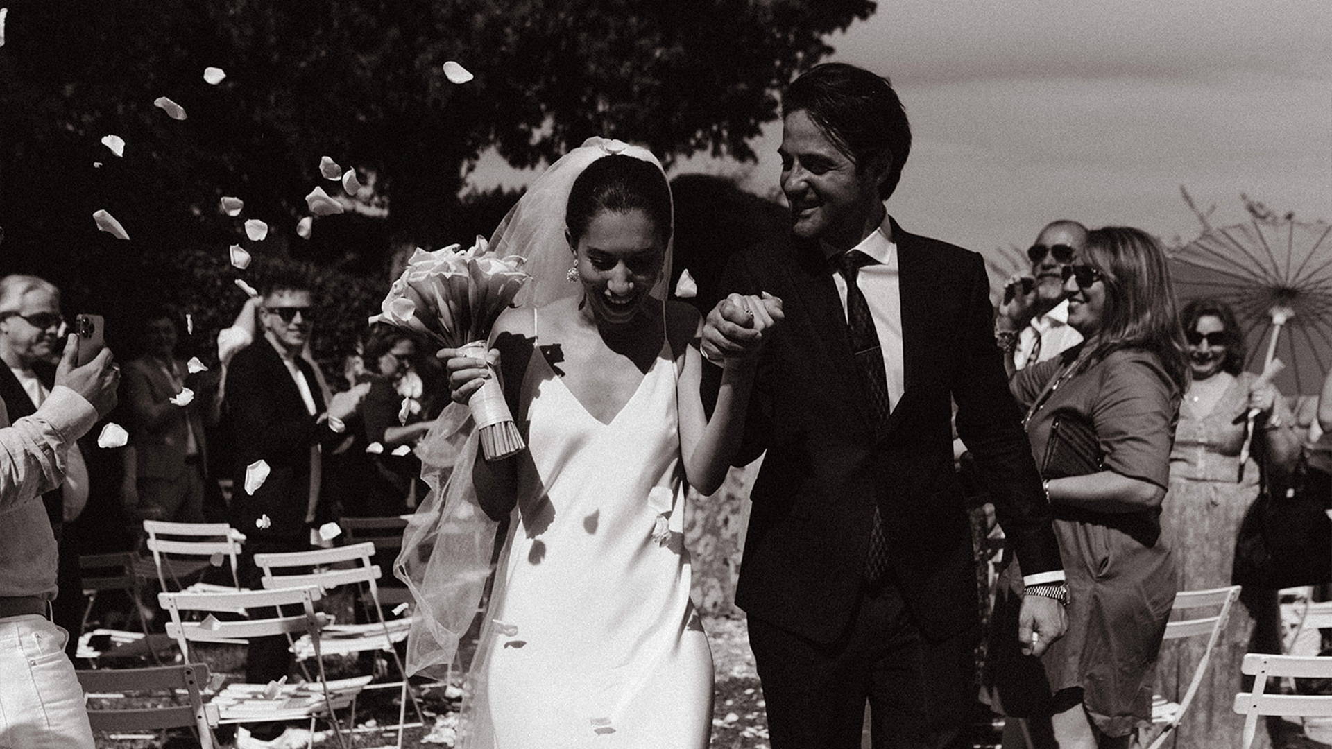 Bride and Groom holding hands walking down the aisle.